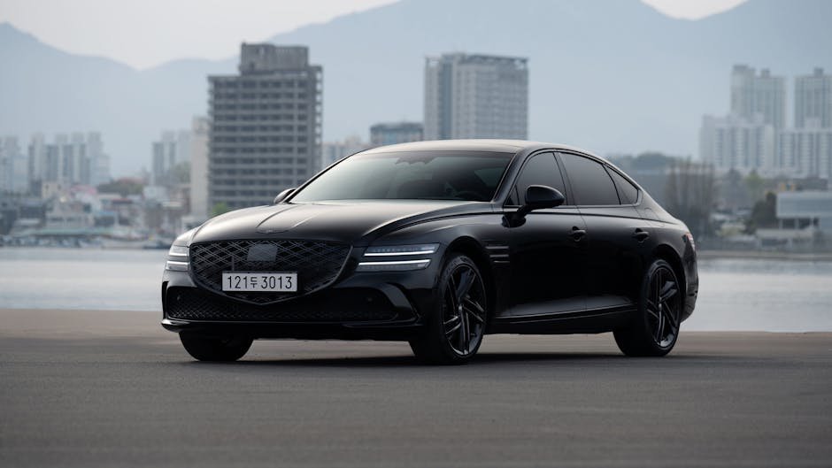 Sleek black sedan parked with a cityscape background, reflecting luxury and modern design.