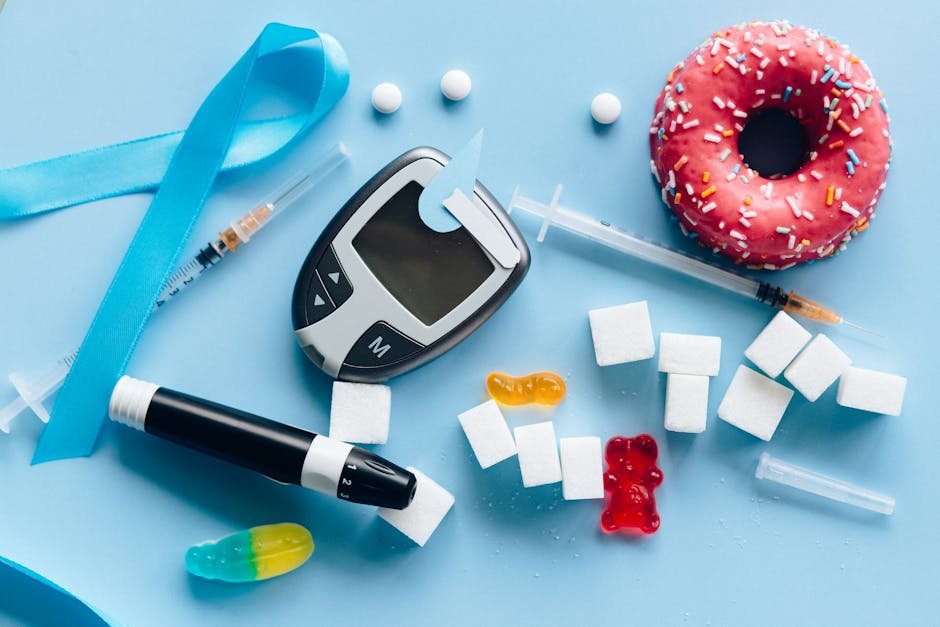 Flat lay of diabetes essentials and sugary food on blue background symbolizing health awareness.
