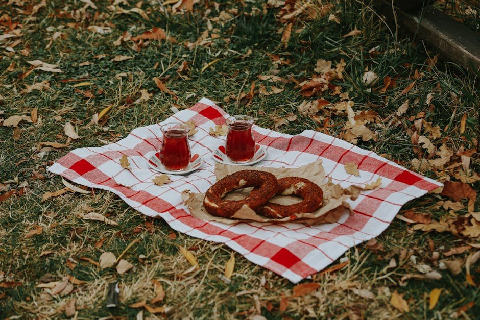 A cozy picnic setup with simit and tea on a fall afternoon in the park.
