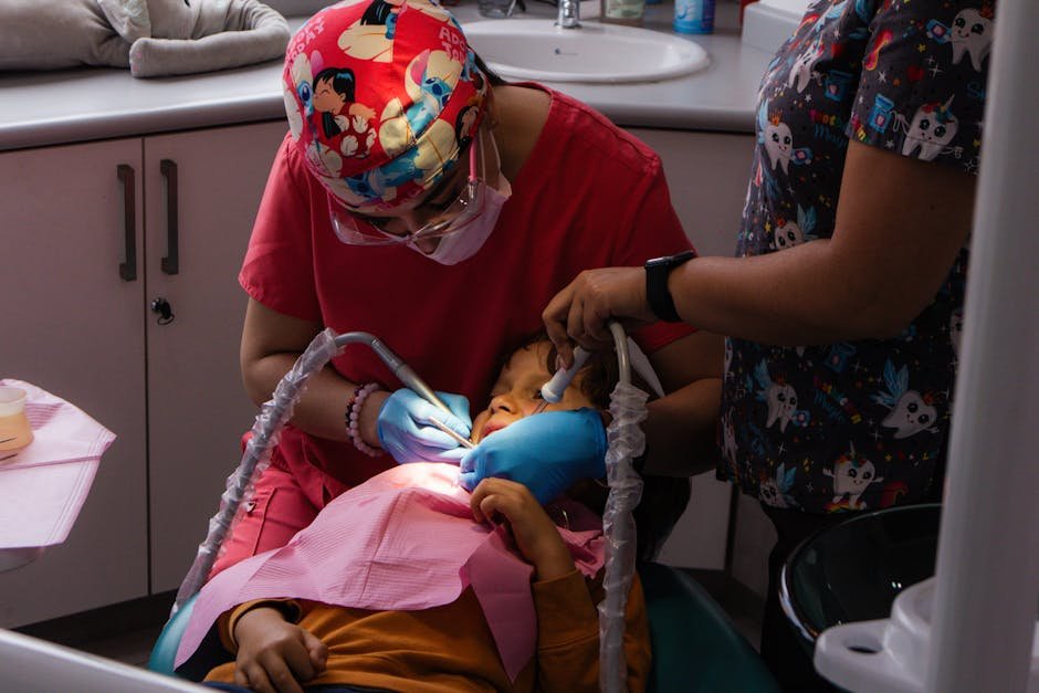 Dentist performing a dental checkup on a child in a clinic setting with colorful attire.